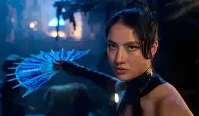 Kitana, a young woman with her hair in a topknot, wields a bladed metal fan as a weapon in Mortal Kombat 2