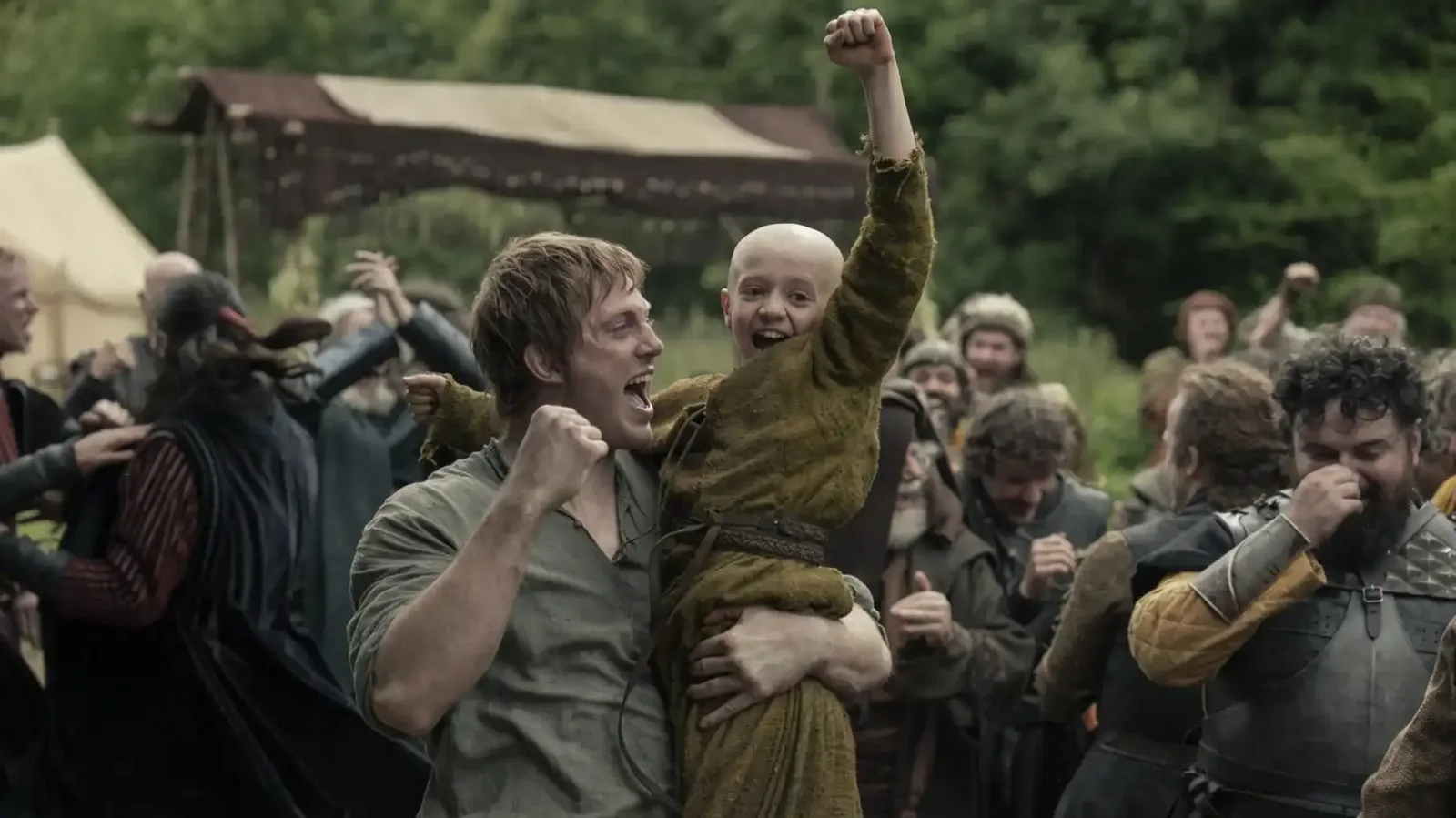 Dunk (Peter Claffey) holding Egg (Dexter Sol Ansell) as they cheer in A Knight of the Seven Kingdoms