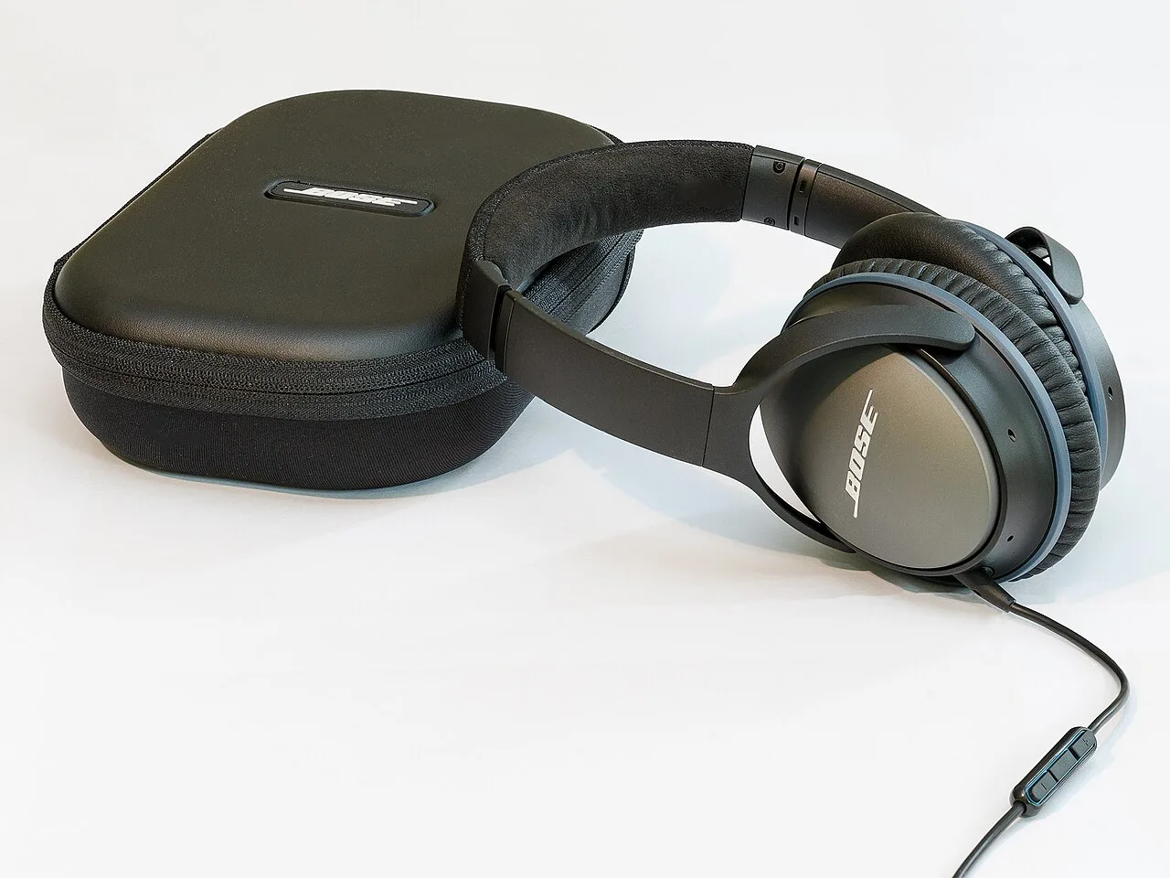 Noise-cancelling headphones alongside a carry case