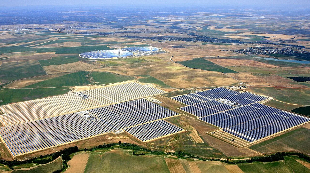 The first three units of Solnova in the foreground, with the two towers of the PS10 and PS20 solar power stations in the background