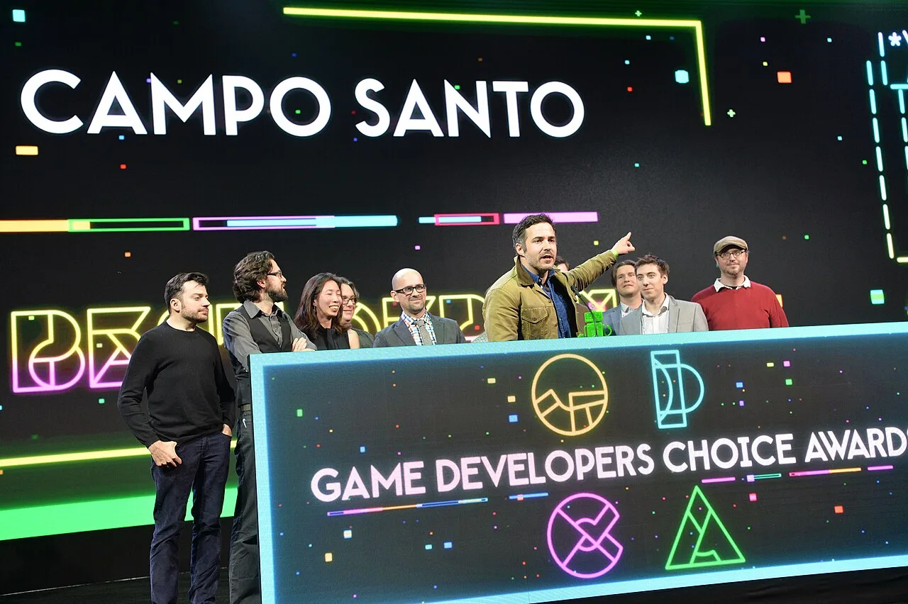 A group of game developers accepts a game developers' award.